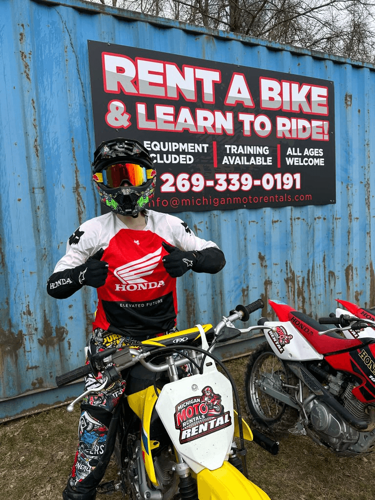 Photo of renter in front of Michigan Moto Rentals sign