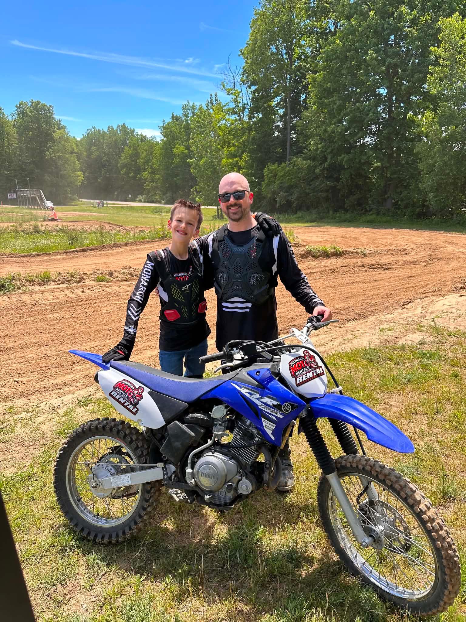 Photo of renter in front of Michigan Moto Rentals sign